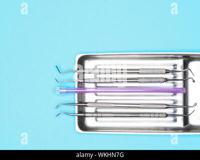 Dental instrument in tray on blue background with copy space. Dental care concept Stock Photo
