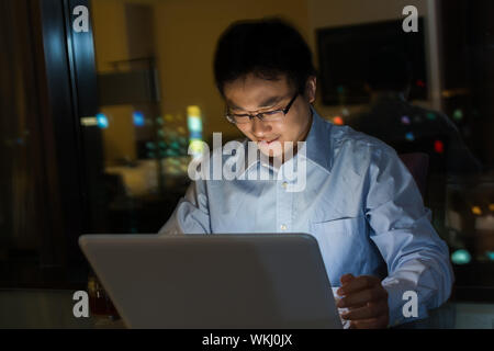 Asian man work at night in the office. Stock Photo