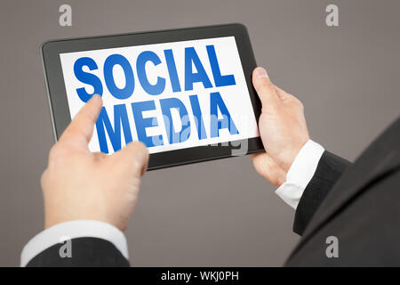 An image of a business man pointing to a tablet pc Stock Photo
