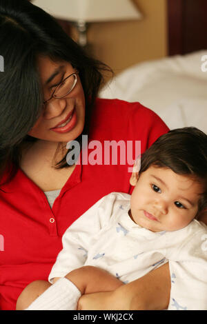 Asian mother and baby waking up with smiles Stock Photo