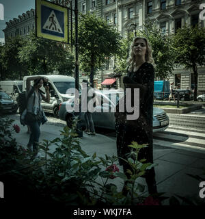 Model being photographed in a photo shoot on a street in St Petersburg, Russia Stock Photo