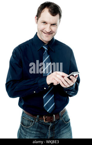 Corporate male executive messaging via phone Stock Photo - Alamy