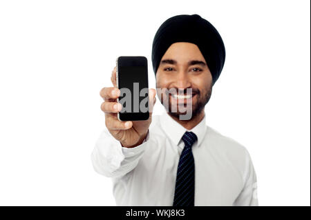 Sales representative displaying newly launched mobile phone Stock Photo