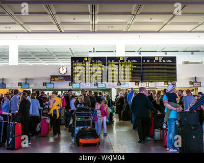 AIRPORT DELAYS STRIKES QUEUES of holiday vacation TUI charter flight passengers and luggage wait on airport concourse to check-in to their flights Lanzarote Spain EU Stock Photo