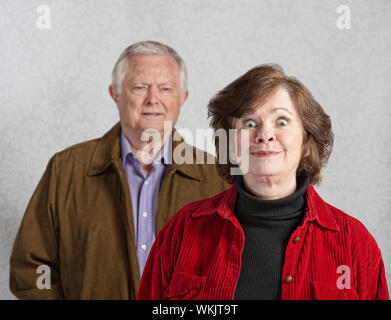 Funny senior European woman teasing confused man Stock Photo