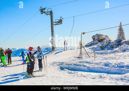 Kopaonik, Serbia - January 20, 2016: Ski resort winter view, ski drag lift, slope and people skiing Stock Photo