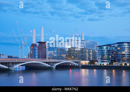 Dusk view across Thames with Farady House and Battersea Power Station redevelopment. Faraday House at Battersea Power Station, London, United Kingdom. Stock Photo