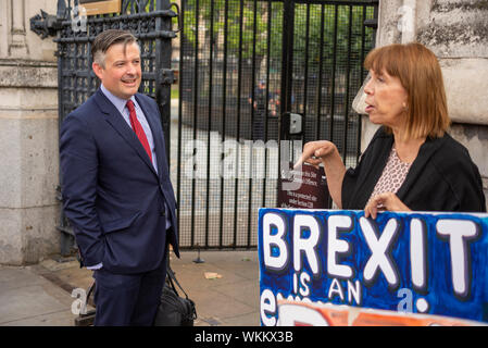 Jonathan Ashworth MP arriving as Parliament resumed after summer recess with debating on No Deal Brexit and prorogue. Speaking with protester Stock Photo