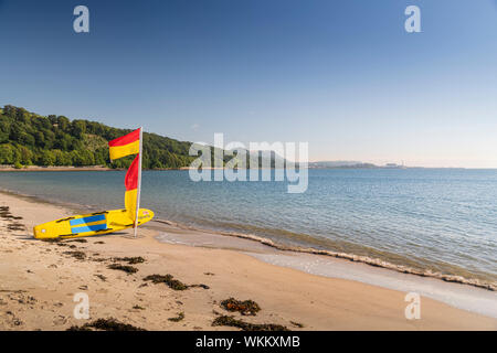 Beach safety flags and surfboard on a Beach in Scotland Stock Photo