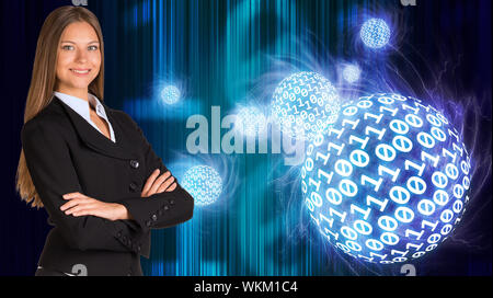 Businesswoman in a suit. Spheres of glowing digits on background Stock Photo