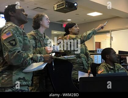 Georgia Army National Guard Soldiers review possible Hurricane Dorian mission scenarios in the Ga, September 3, 2019. DoD Joint Operations Center in Marietta, Ga. Sept 3, 2019. The Soldiers are Sgt. 1st Class Toya Cullwell, Sergeant Major Rachel Dryden, Sgt. Shaztada Wilson and Sgt. Eric Cooper. () Stock Photo