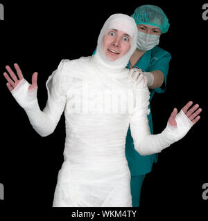 Funny sick in bandage and nurse isolated on black background Stock Photo