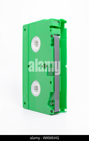 VHS tape on vertical with open cover and the magnetic tape exposed. Green VHS, Video Home System. Stock Photo