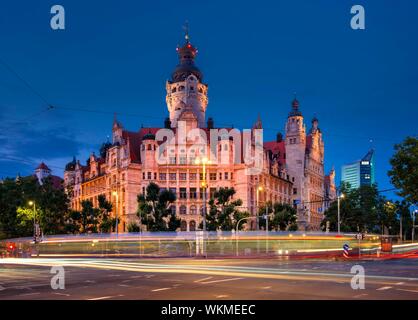 The New Town Hall on Martin-Luther-Ring, the City Tower in the back, night shot, light tracks of the tram, Leipzig, Saxony, Germany Stock Photo