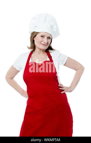 Mature female chef posing with hands on her waist Stock Photo