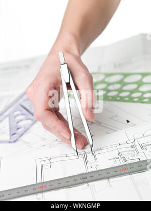 Male architect working on a bluprint, close up on hand and bluprint. Stock Photo