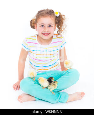 Happy little girl holding baby chickens - isolated white background Stock Photo