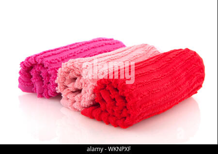 Rolled towels in pink and red isolated over white Stock Photo