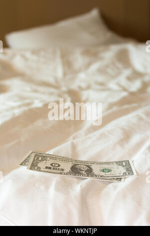 Tips at the bed for the housekeeper in hotel. Stock Photo