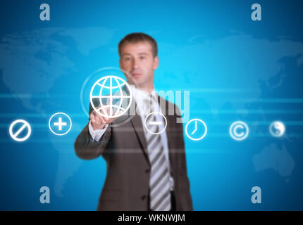 Businessman in suit pointing her finger at cloud icons. World map as backdrop Stock Photo