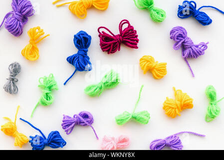 Multi-colored bandaged threads for needlework. Materials to do the work at home. Making warm clothes. Knitting. Stock Photo