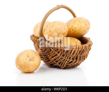 Golden Potatoes in wicker basket over white background Stock Photo