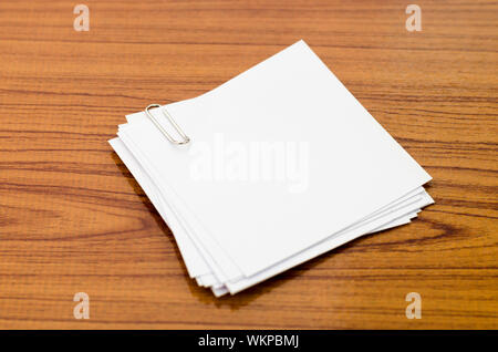 stack of paper with clip on wood background Stock Photo