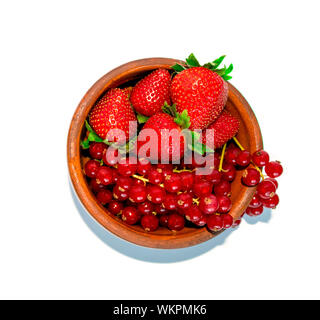 Fresh ripe berry mix. Red currant and strawberry in a brown bowl on white background isolated. Healthy food, summer berries, slimming food. Flat lay. Stock Photo