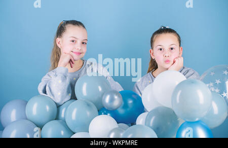 Carefree childhood. Sisters organize home party. Having fun concept. Balloon theme party. Girls best friends near air balloons. Start this party. Birthday party. Happiness and cheerful moments. Stock Photo