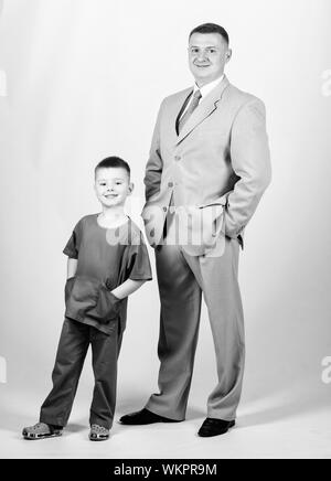 happy child with father. business partner. small boy doctor with dad businessman. childhood. trust and values. fathers day. family day. father and son in business suit. future career. Stock Photo