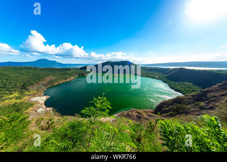 View of cones of Taal Volcano and the wind ruffled emerald green water in the Lake Taal on a sunny day in Tagaytay, Philippines. Stock Photo
