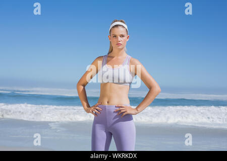 Sporty focused blonde on the beach on a sunny day Stock Photo