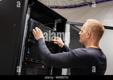 IT Engineer Working With Servers In Datacenter Stock Photo