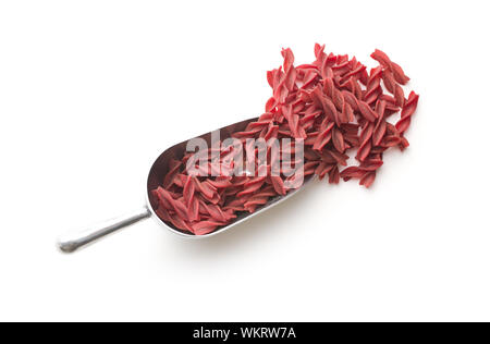 Uncooked colorful pasta with beetroot flavor isolated on white background. Stock Photo