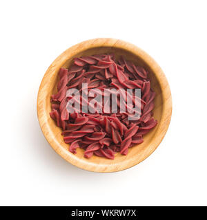 Uncooked colorful pasta with beetroot flavor isolated on white background. Stock Photo