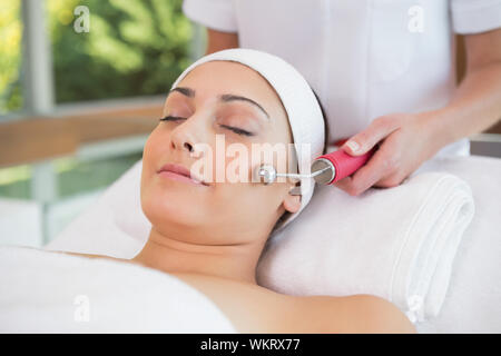 Peaceful brunette getting micro dermabrasion in the health spa Stock Photo