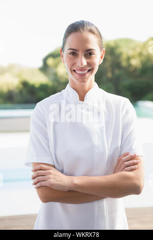 Smiling beauty therapist looking at camera outside at the spa Stock Photo