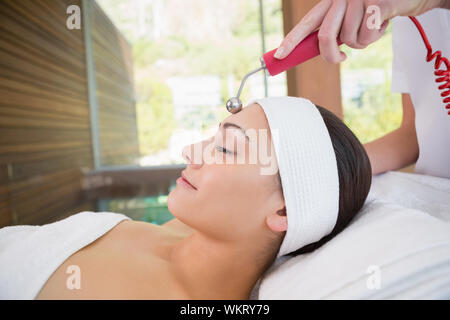 Peaceful brunette getting micro dermabrasion in the health spa Stock Photo