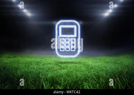 Cloud in shape of phone against football pitch with bright lights Stock Photo