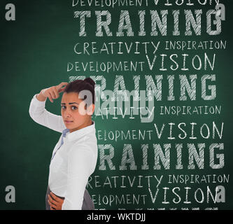 Worried businesswoman against green chalkboard with business buzzwords Stock Photo