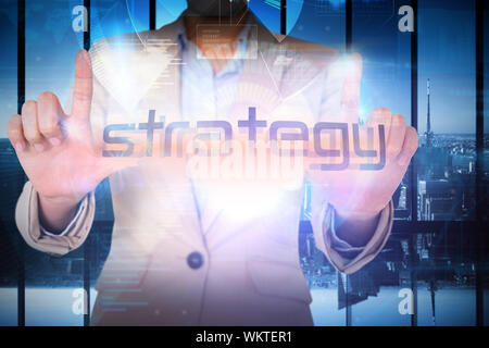 Businesswoman presenting the word strategy against room with large window looking on city Stock Photo