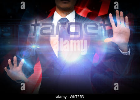Businessman presenting the word target against shiny red arrows on black background Stock Photo