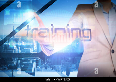 Businesswoman presenting the word training against room with large window looking on city Stock Photo