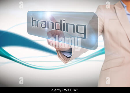 Businesswoman pointing to word branding against abstract blue line son white background Stock Photo