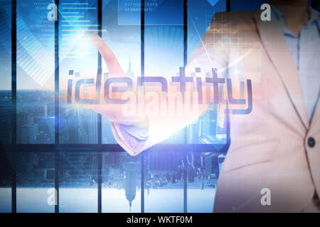 Businesswoman presenting the word identity against room with large window looking on city Stock Photo