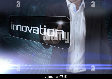 Businessman pointing to word innovation against spiral of shiny binary code Stock Photo