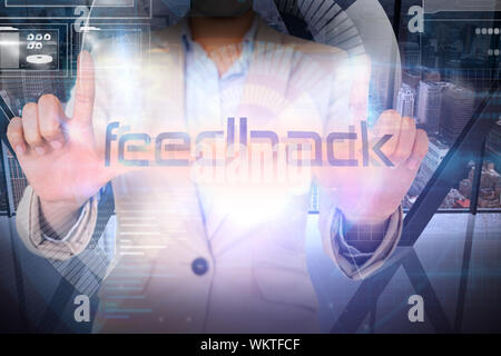 Businesswoman presenting the word feedback against room with large window looking on city Stock Photo