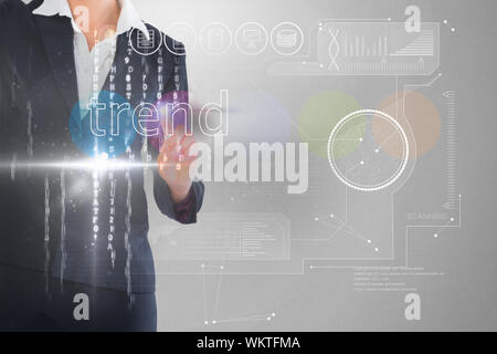 Businessman touching the word trend on interface against grey vignette Stock Photo
