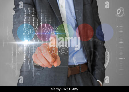 Businessman touching the word solve on interface against grey vignette Stock Photo