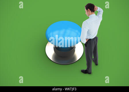 Thinking businessman scratching head against green background Stock Photo